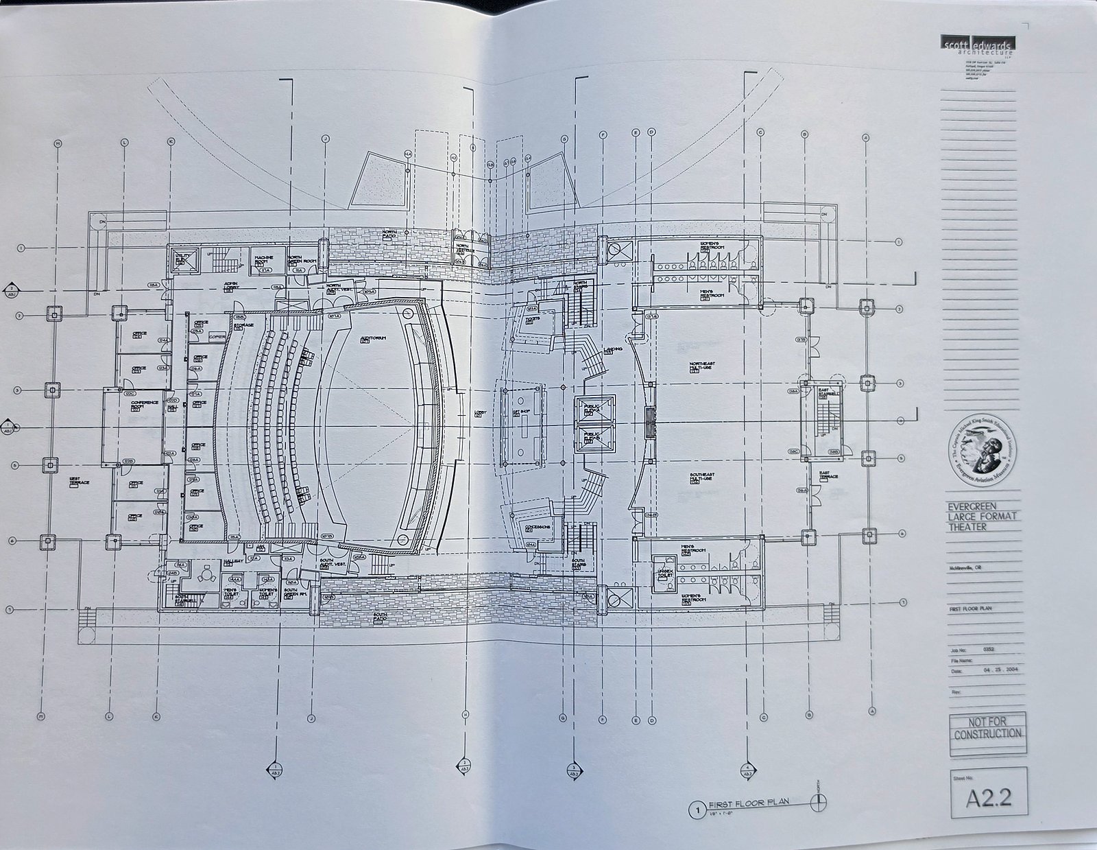 Architectural sheet A2.2, First Floor Plan of the Evergreen Large Format Theater, with a curved auditorium on the left, a lobby in the middle and a multi-use space on the right, and the museum's seal in the title block
