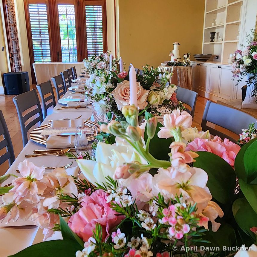 Pink and white flower centerpieces on a long table